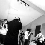 a black and white back shot of the band hallows recording a live session at let down studio in the tracking room