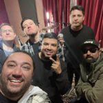 a selfie group photo of hector gomez and john garcia smiling with the band scairat in the tracking room of let down studio.